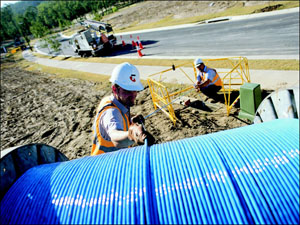 Telstra workers laying fibre