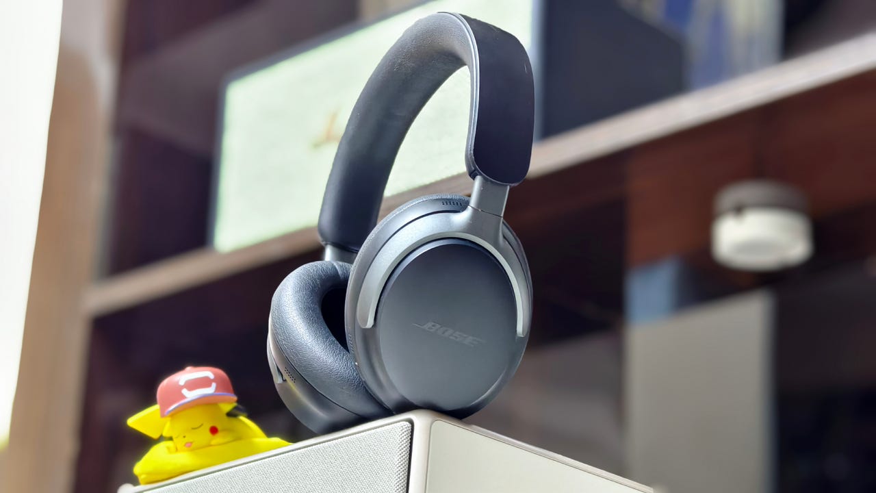 Bose QuietComfort Ultra headphones with a sleeping Pikachu toy on the left.