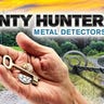 A composite image of the Bounty Hunter Tracker IV, the Bounty Hunter logo, and a person's hand holding a key and a few coins.