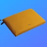 A brown laptop sleeve against a blue background