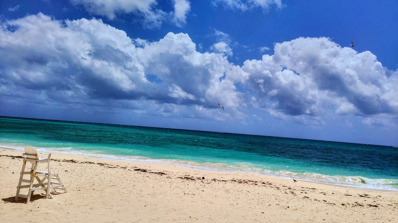 An empty High Rock Beach, Grand Bahama beach with blue skies above.