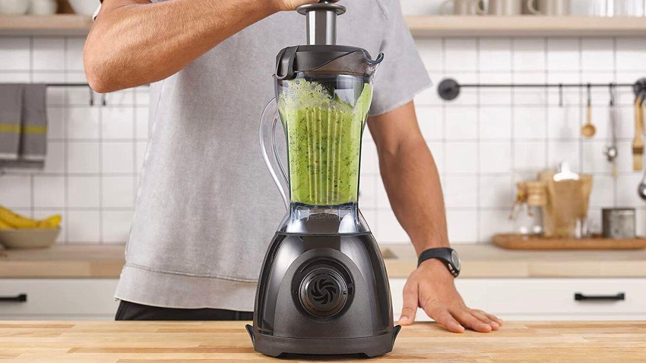 Blender with green stuff being blended inside of it