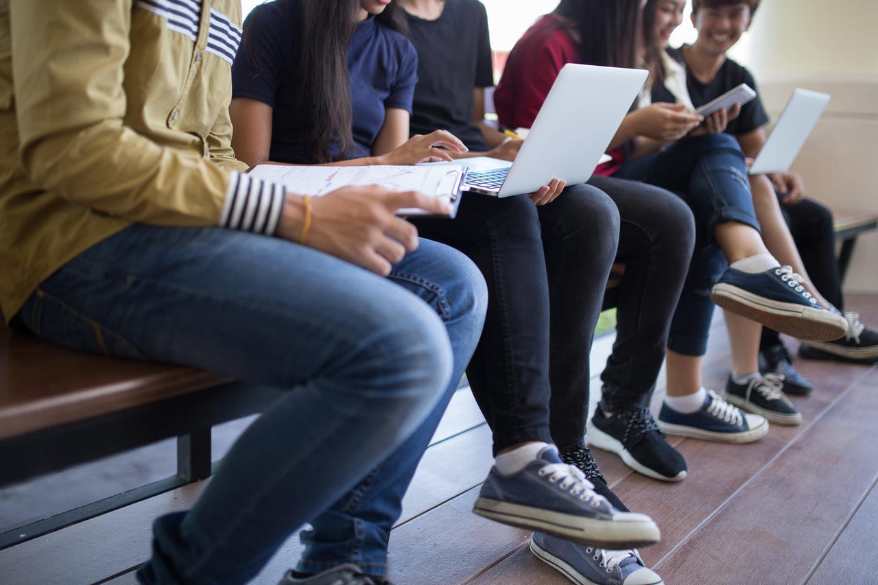 A group of college students with laptops
