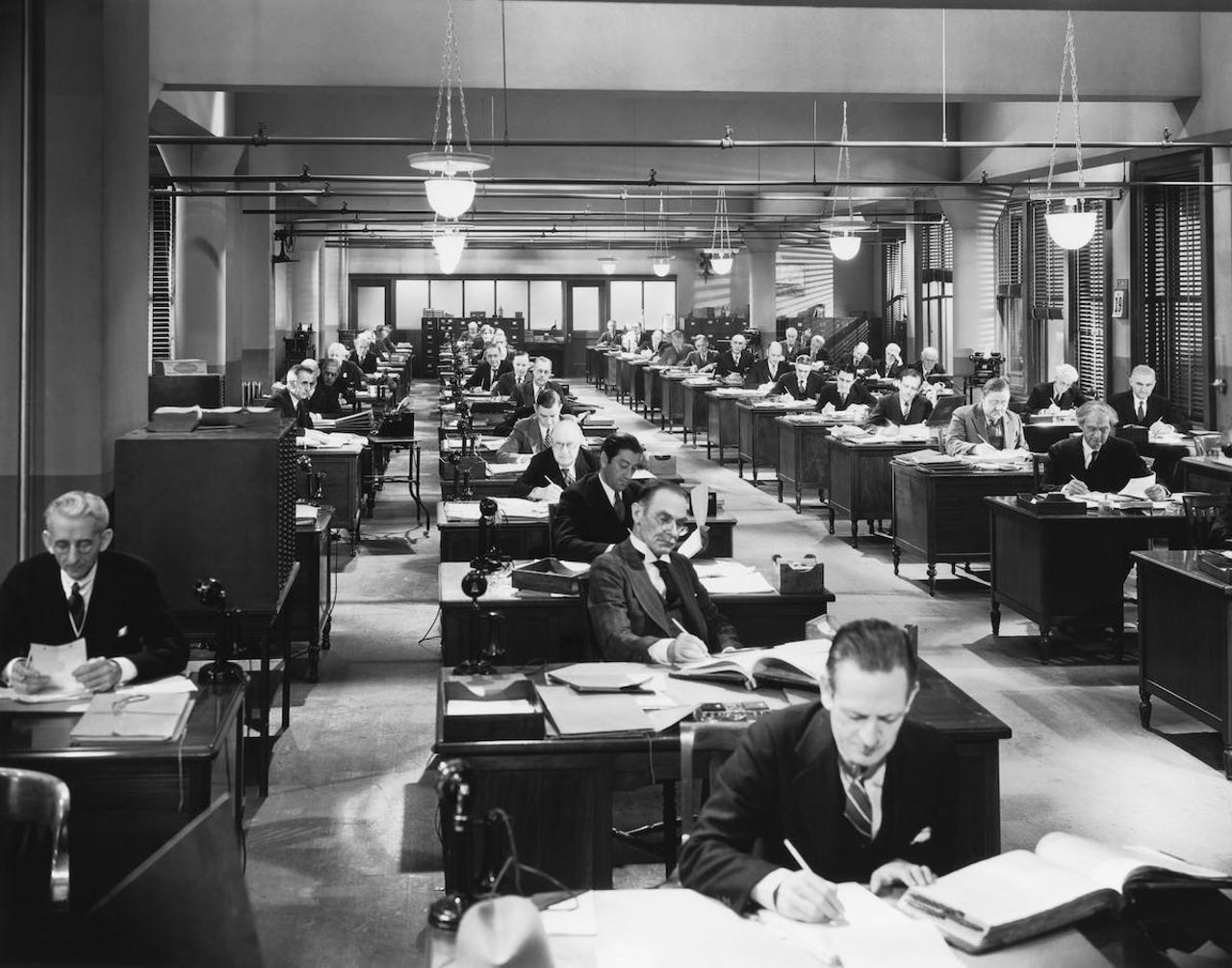 Vintage office building interior with people working at their desks