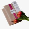 Two wrapped packages with a bookmark and a bouqet of flowers on top of it