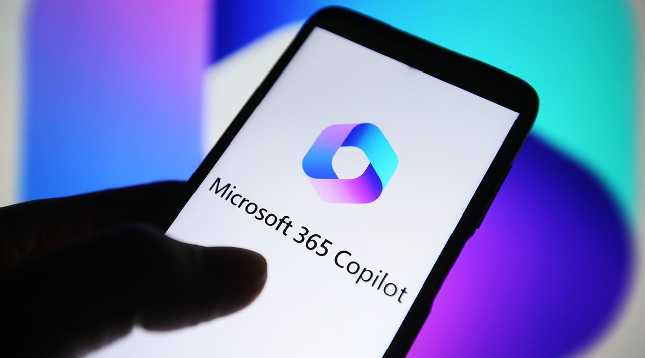 Image of a hand holding a phone with the Microsoft 365 logo