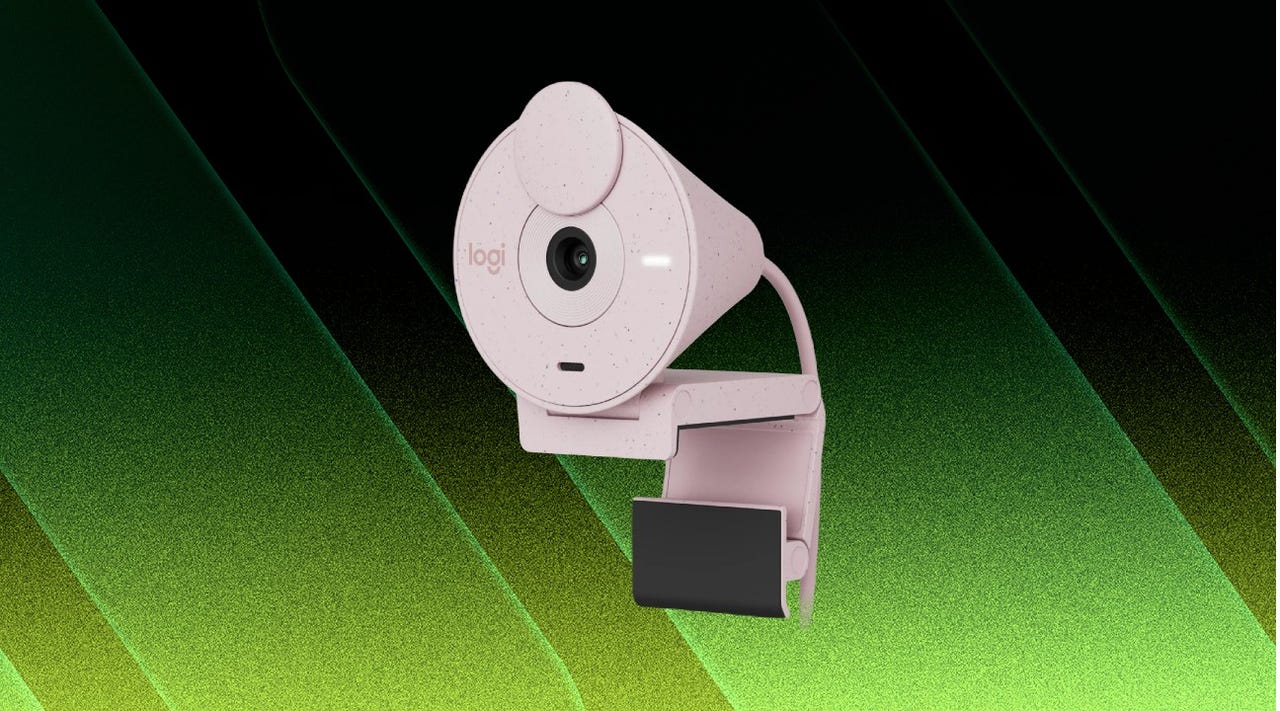 Rose pink Logitech Brio 300 webcam against a green and black background