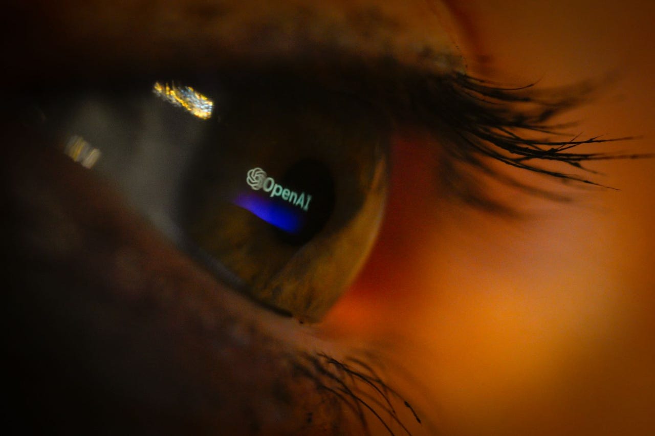 The OpenAI logo is seen reflected in an eye