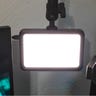 Close-up of an Elgato Key Light Mini. It is illuminated with a bright white light.