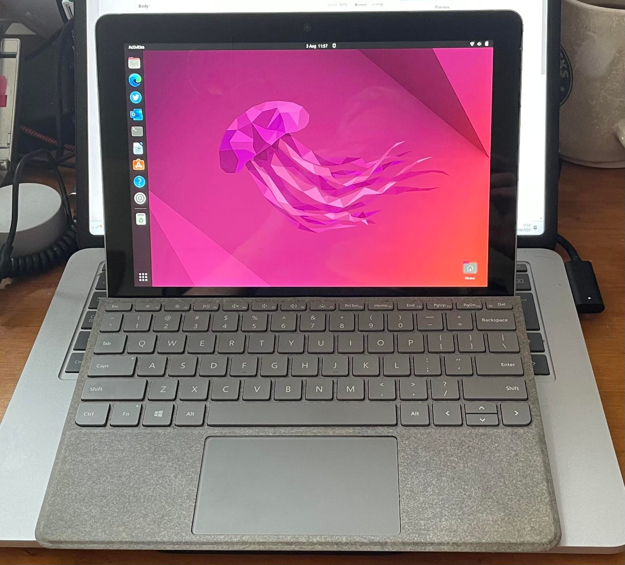Ubuntu running on a Surface Go showing a stylized jellyfish on a pink screen