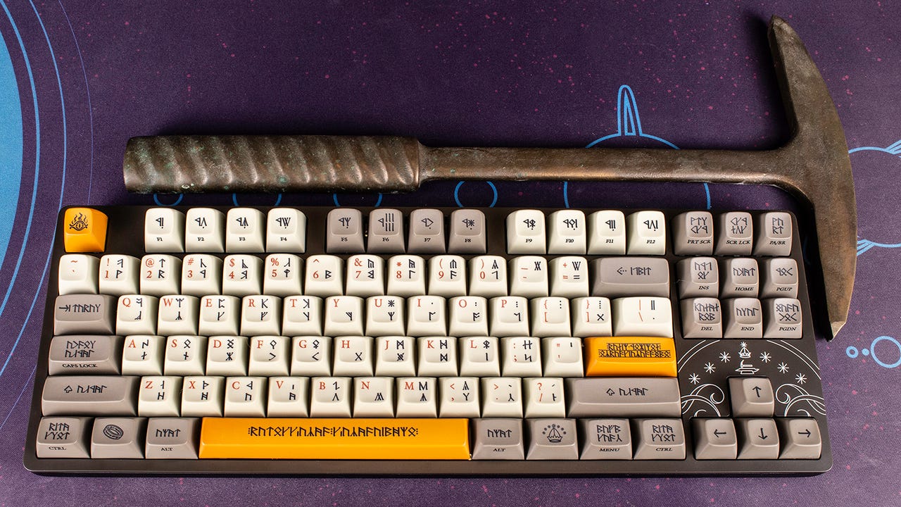 Drop's Dwarvish keyboard on a desk next to a small pickaxe