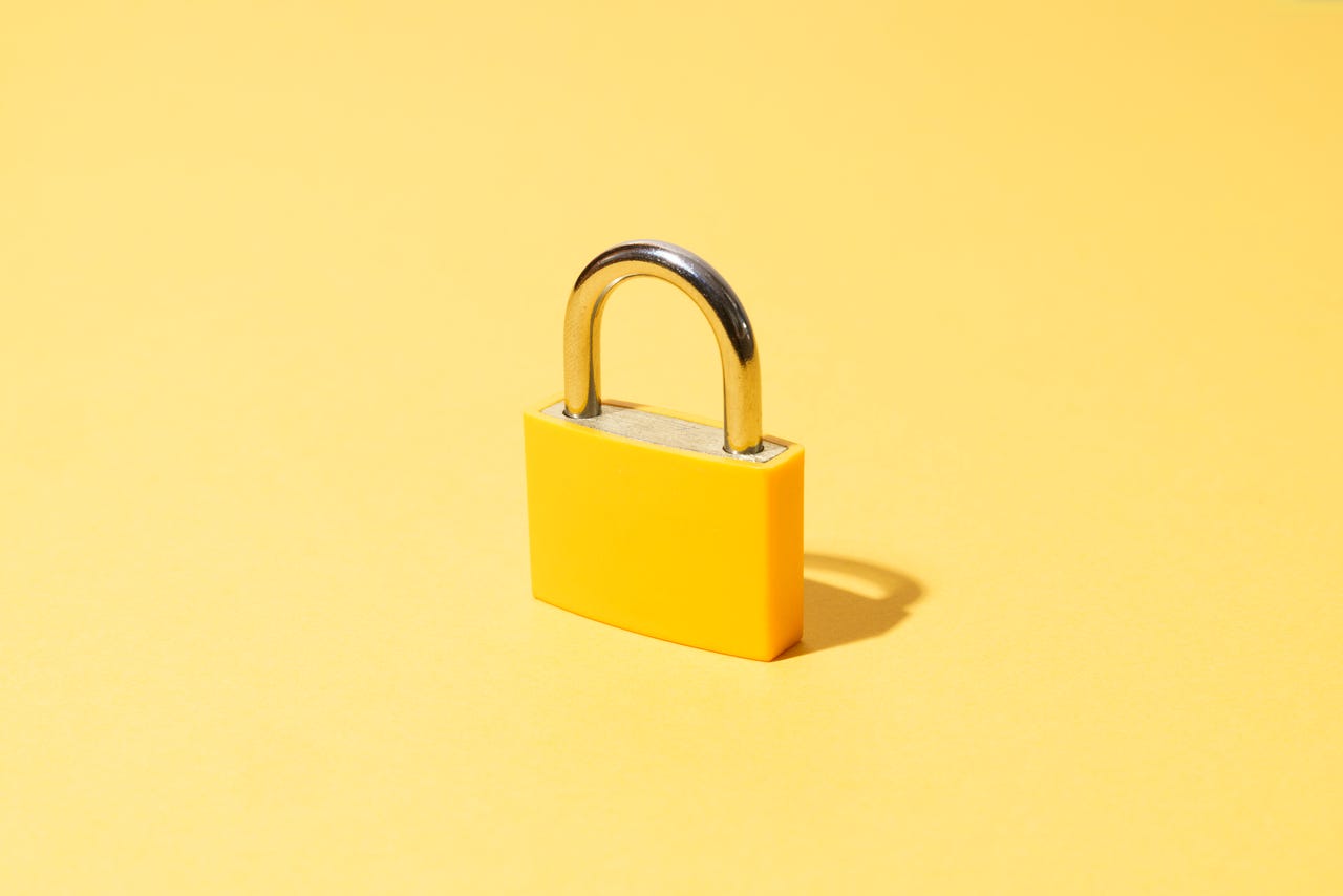 A yellow lock on a yellow background