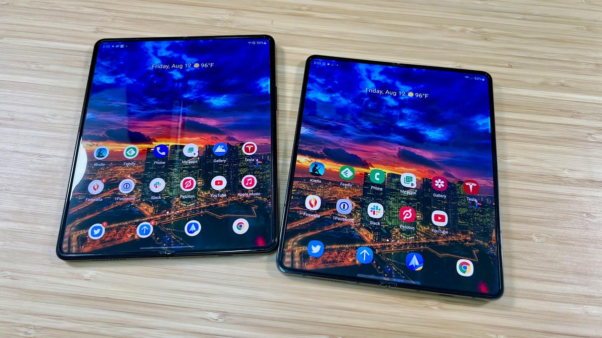 A Samsung Galaxy Z Fold 3 and Z Fold 4 side by side with the same wallpaper