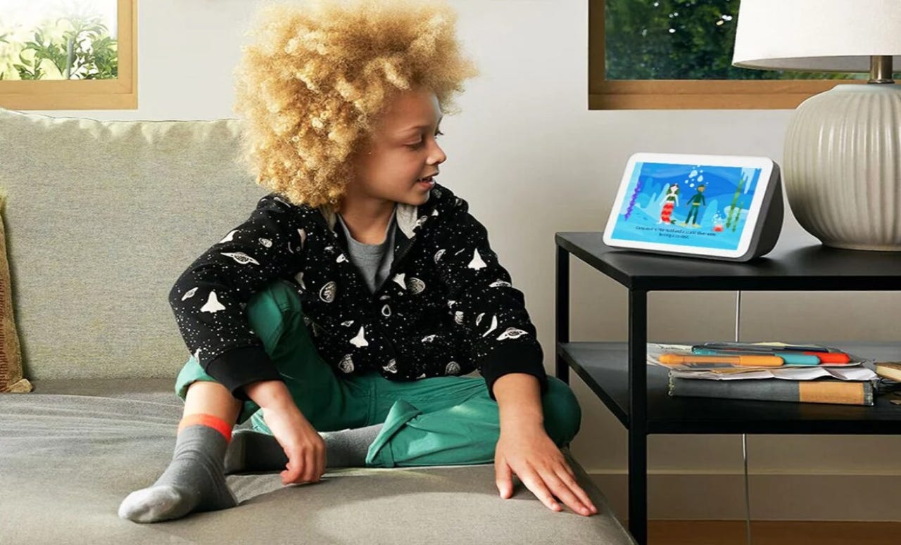 A child sitting on the couch using Create With Alexa is shown on the Echo Show device