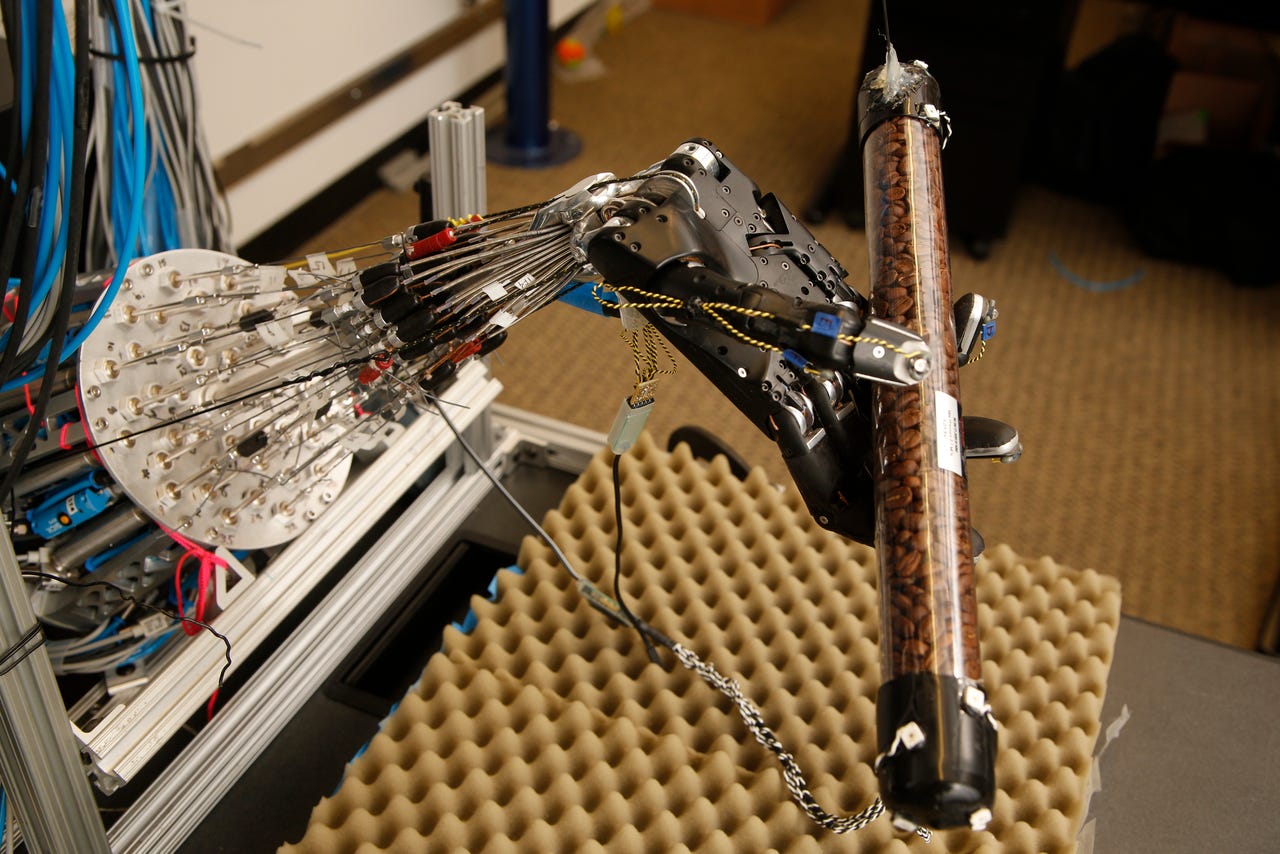 a dexterous robotic hand grasps a cylinder