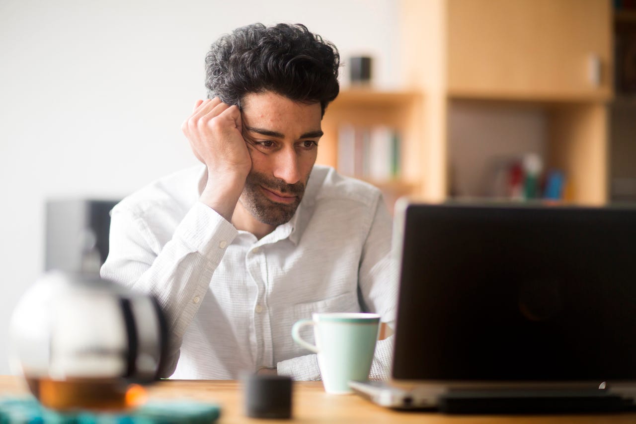 frustrated man working on laptop