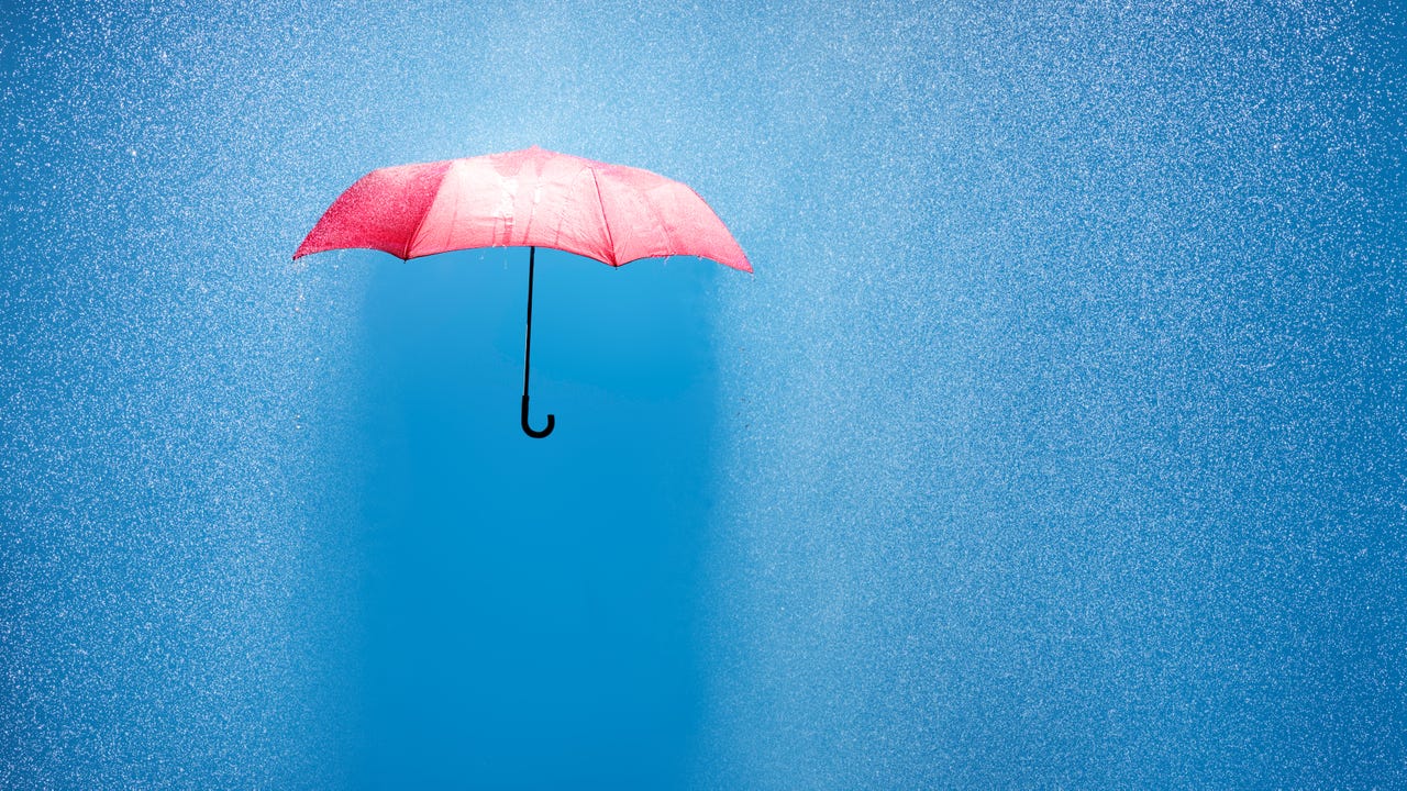pink umbrella in a rain shower, conceptually photographed