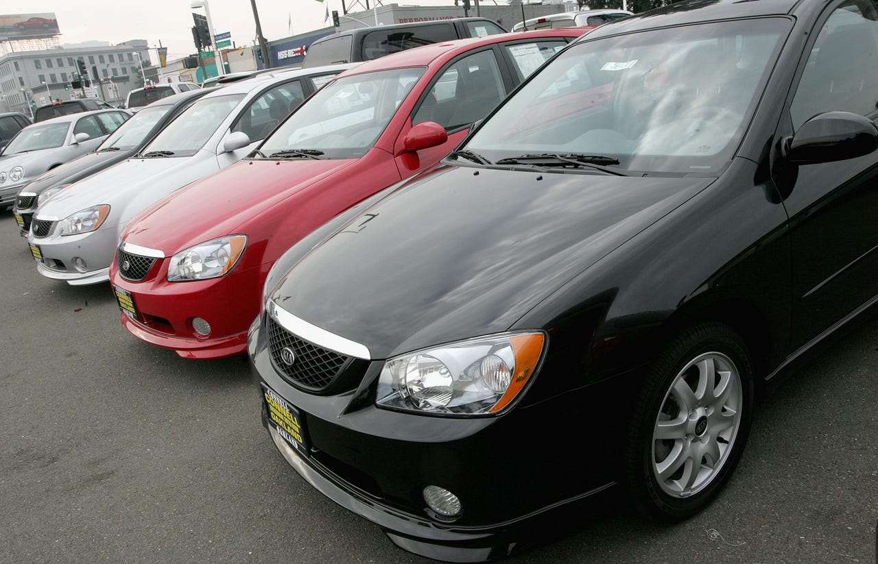 A row of 2005 KIA Spectras are seen on display at a Kia dealership