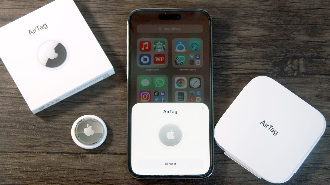 AirTag and its box placed near iPhone