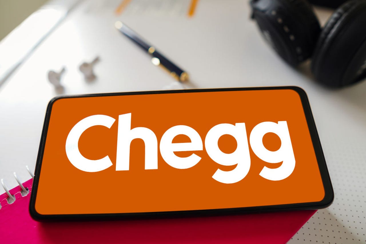 Chegg logo on a phone on a desk
