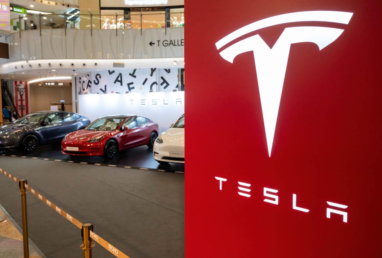 Tesla logo with cars in background