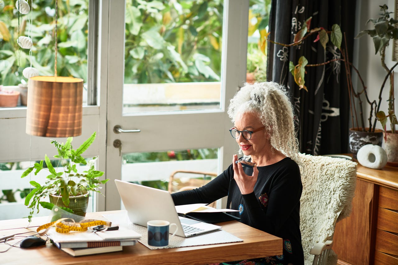 a-woman-working-from-home-with-her-laptop-and-smartphone
