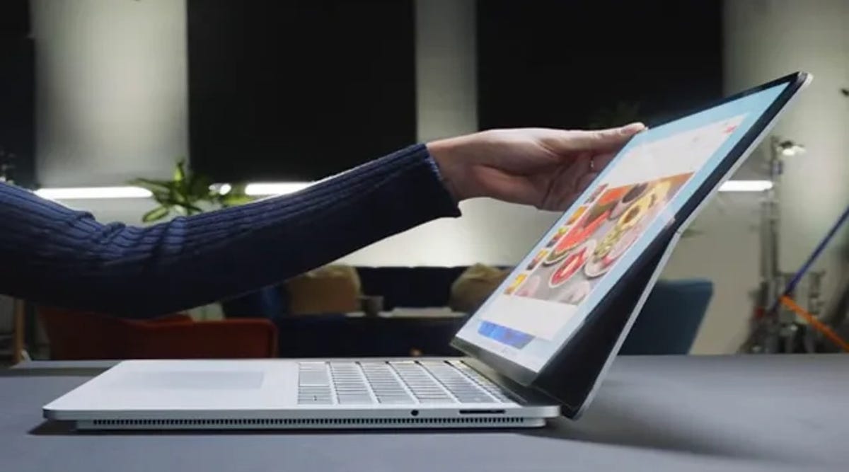Person using Microsoft Surface Laptop Studio.
