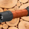 Image of Coast Polysteel 600R 530 Lumen Rechargeable LED Flashlight with a blurred background of chopped wood.