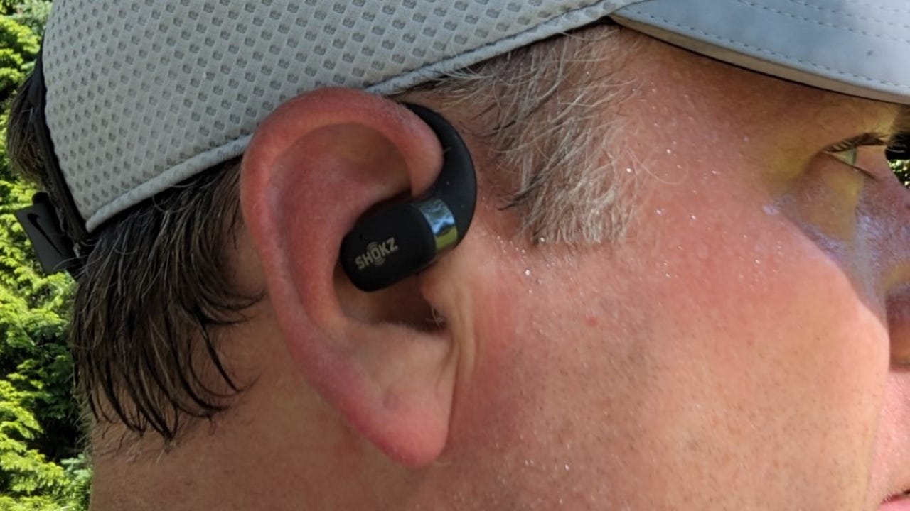 A person wearing the Shokz Openfit earbuds