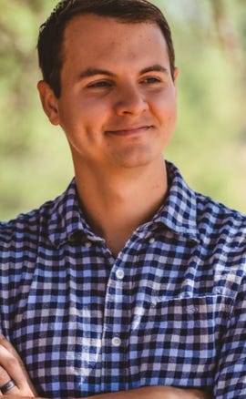 Blaine Thiederman, a man with short brown hair, smiles outside.