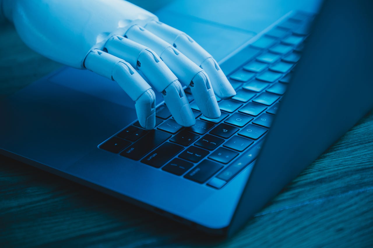robot hand on laptop