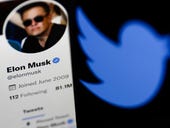 Elon Musk says Twitter deal is 'temporarily on hold' but he's 'still committed'