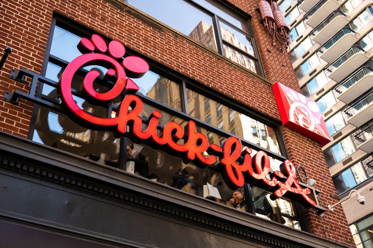 Chick-fil-A signboard against brick building