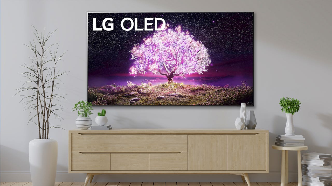 LG OLED C1 Series 65" on wall with Modern Mid Century Interior Of Living Room, Wood Tv Cabinet With Plant On Wood Flooring - stock photo