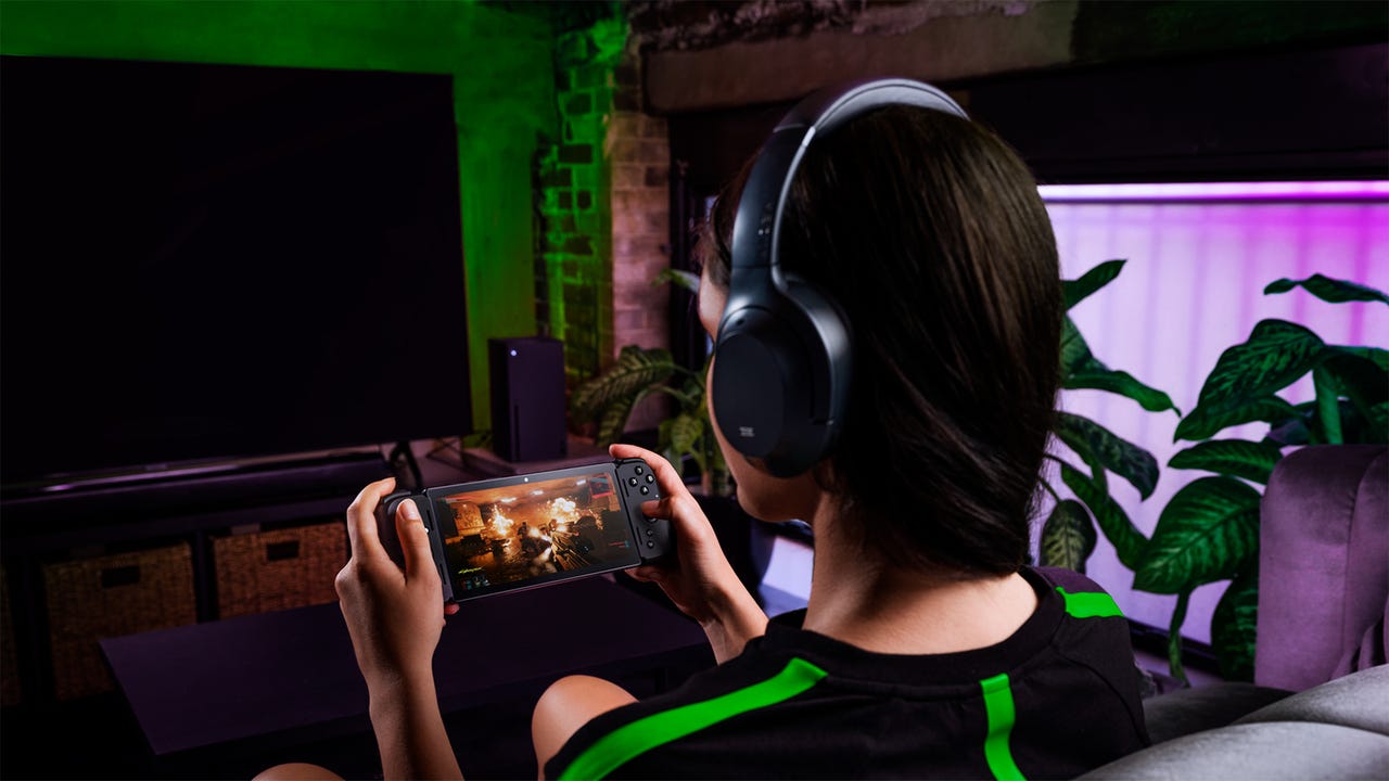 A woman playing Razer's Edge gaming portable