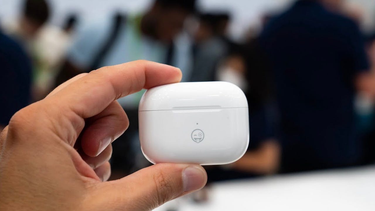 AirPods in hand at Apple's event.