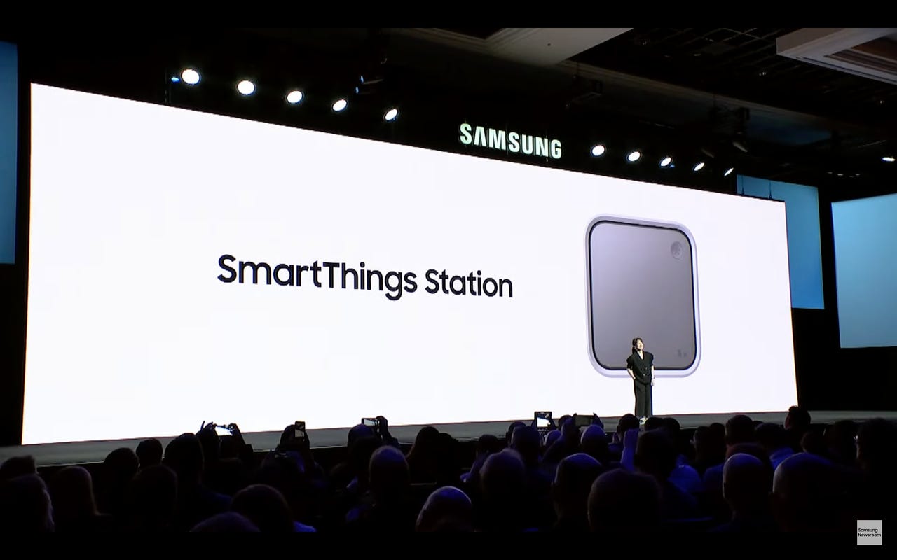 Presenter in front of huge screen showing square SmartThings Station 