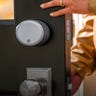 Close up of person opening a door with a smart lock on it