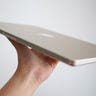 Holding up the MacBook Air 15-inch in Starlight