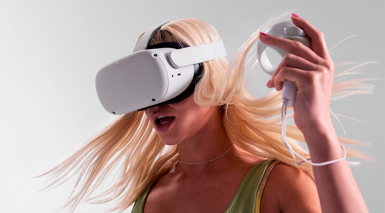Close-up of a young, blonde woman wearing a Meta Quest 2 VR headset