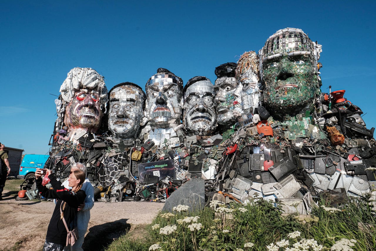 Monument of e-waste molded to look like the leaders of the top 7 e-waste producing countries