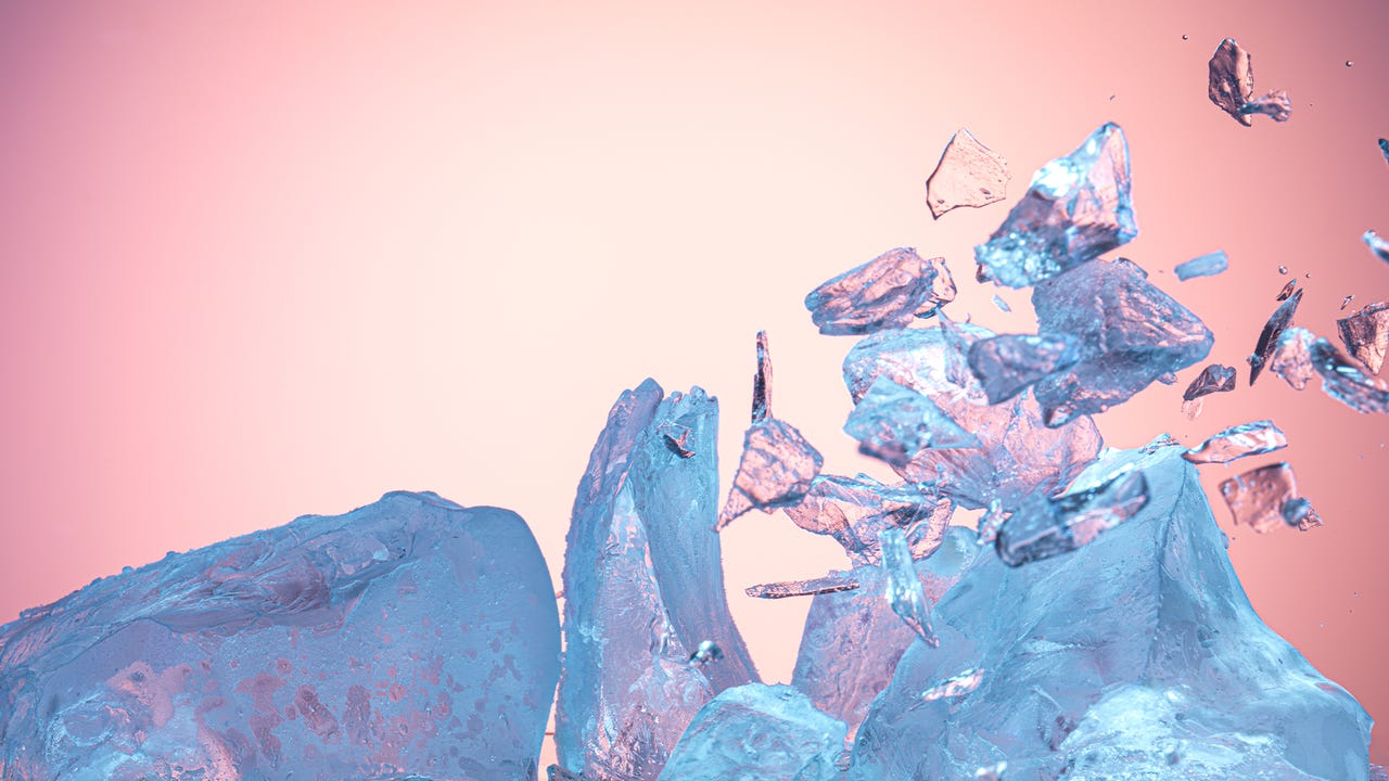 Blue ice block exploding on pink background