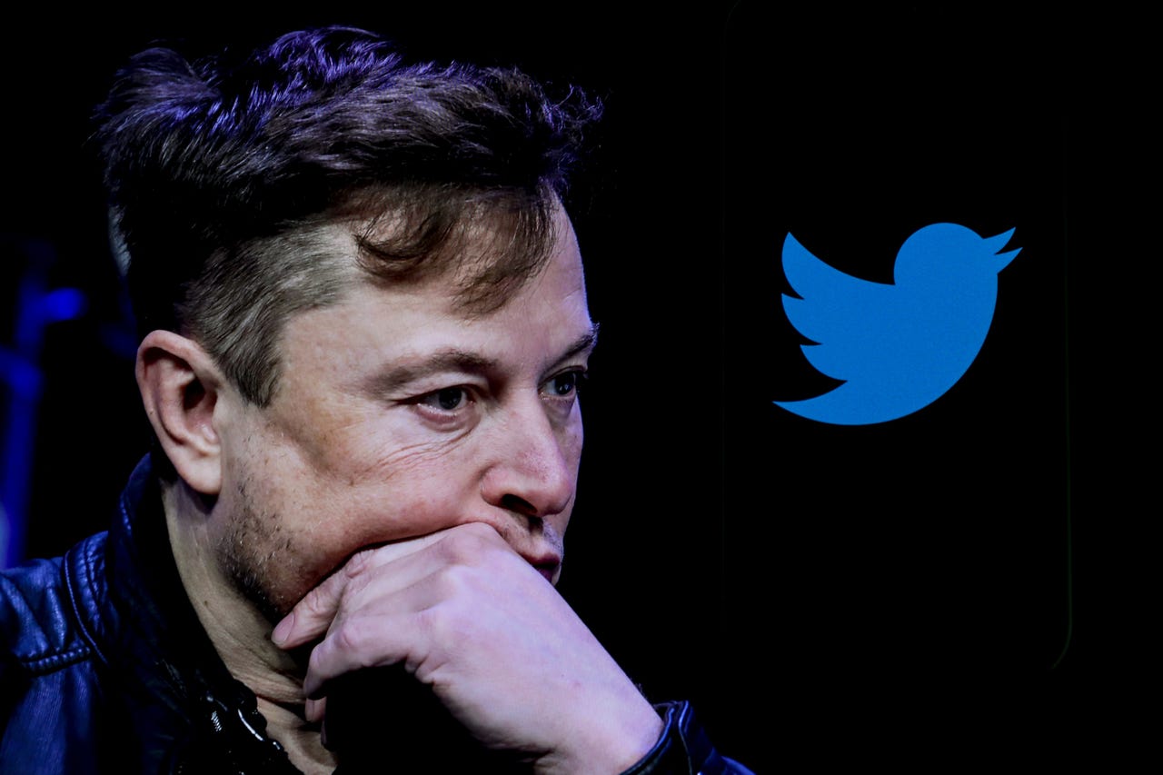 Musk pensive with a Twitter logo in background