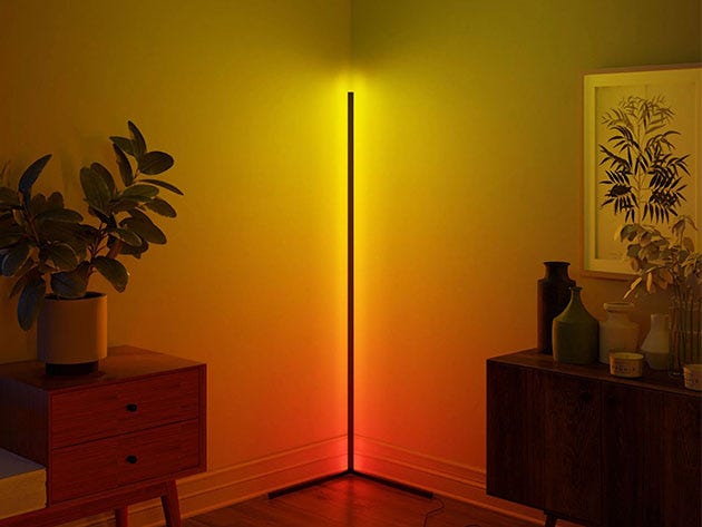 Dim room corner lit up in red, orange, and yellow by a lamp