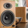 Two bamboo bookshelf speakers on a table