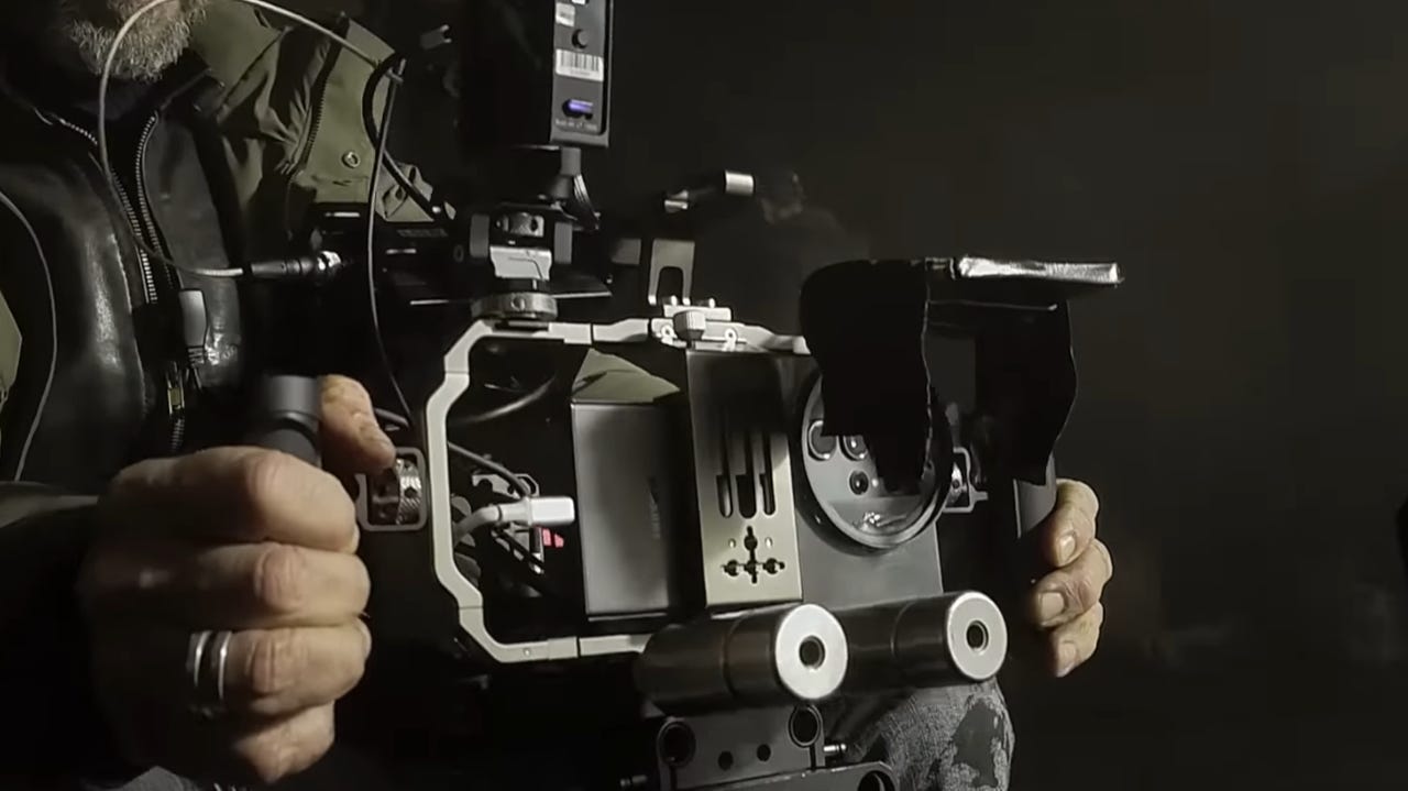 Person holding a rigged up Samsung Galaxy S23 Ultra for filmmaking.