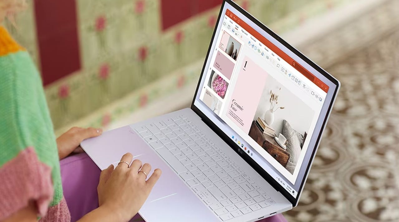 Image of a person scrolling on an LG gram style laptop.