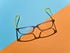 A pair of glasses against a blue and orange background