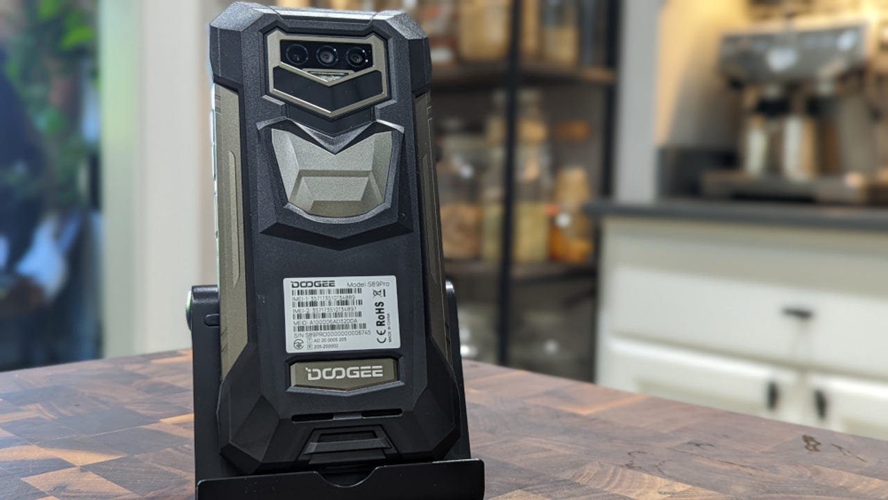 The Doogee S89 Pro in a stand on a table.