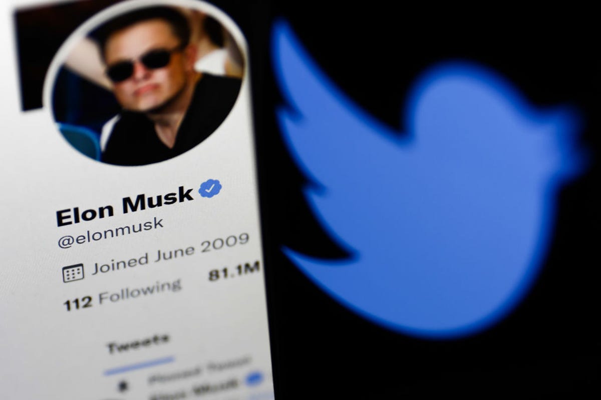 Elon Musk Twitter profile displayed on a computer screen and Twitter logo displayed on a phone screen